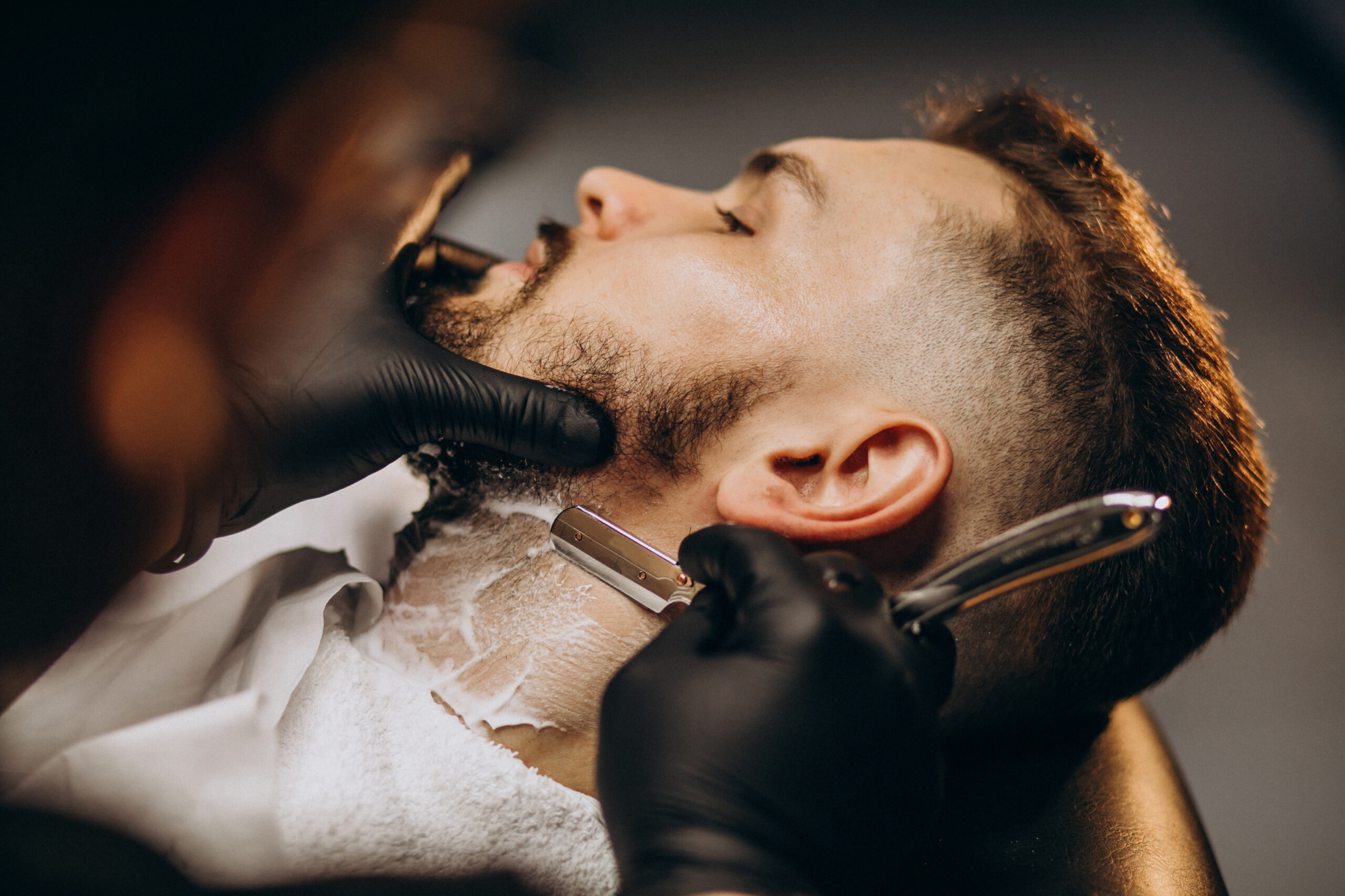 handsome-man-cutting-beard-barber-salon-scaled.jpg