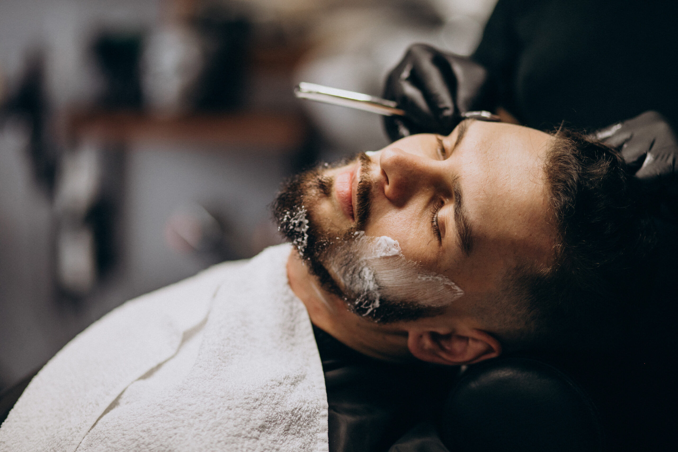 handsome-man-cutting-beard-barber-salon1-scaled.jpg